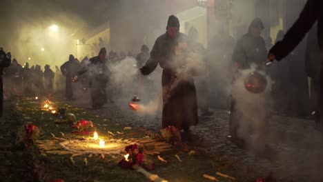 Purple-robed-priests-carry-incense-burners-at-night-in-a-colorful-Christian-Easter-celebration-in-Antigua-Guatemala