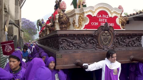 Cucharuchos-struggle-to-carry-a-massive-float-during-Easter-in-Antigua-Guatemala