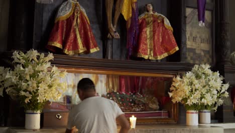 A-man-worships-at-an-alter-in-the-Santiago-Atitlan-church-where-Stanley-Rother-was-murdered