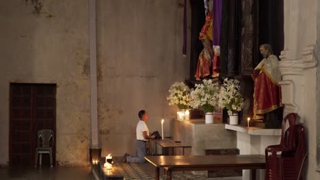 A-man-worships-at-an-alter-in-the-Santiago-Atitlan-church-where-Stanley-Rother-was-murdered-1