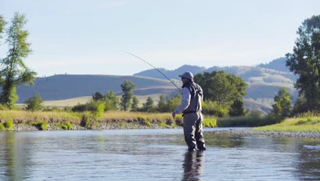 A-fly-fisherman-on-a-beautiful-summer-morning-casts-for-trout-in-a-Montana-river-1