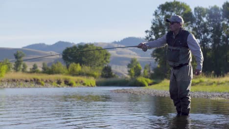 A-fly-fisherman-on-a-beautiful-summer-morning-casts-for-trout-in-a-Montana-river-3