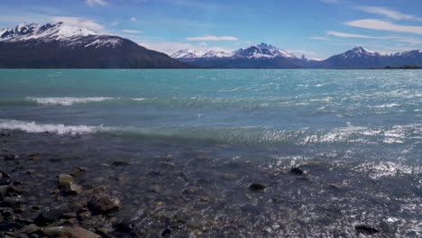 Scenic-snow-covered-peaks-and-blue-wind-whipped-water-of-Lago-Argentina-near-Puerto-Bandera-Argentina