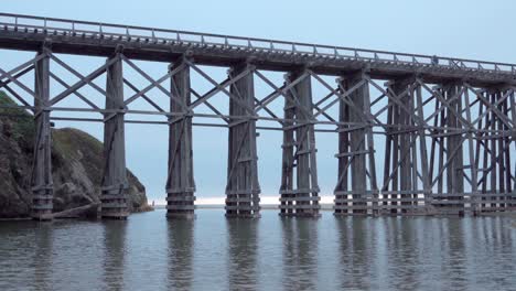 A-historic-wooden-train-tressel-spans-the-beach-where-Pudding-Creek-enters-the-Pacific-Ocean-in-Fort-Bragg-California-1