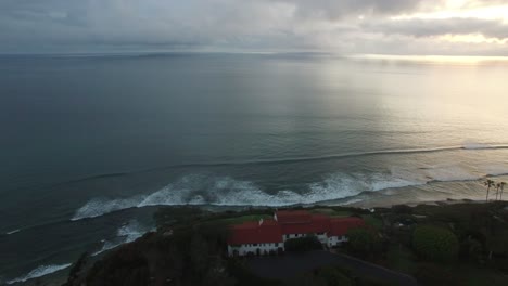 A-beautiful-aerial-above-waves-rolling-into-the-California-coastline-north-of-San-Diego-1