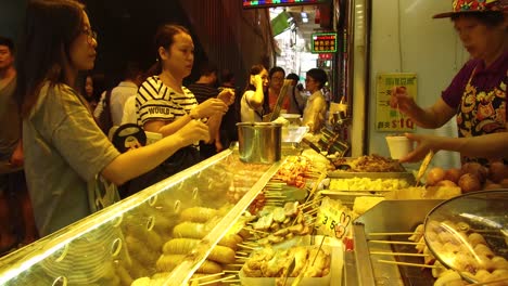 A-Chinese-woman-prepares-food-at-a-street-stall-in-Hong-Kong-China