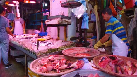 A-meat-seller-in-Hong-Kong-cuts-meat-with-a-knife-for-a-customer-1
