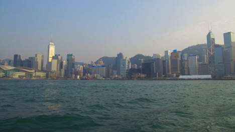 Establishing-shot-from-the-ferry-boat-reveals-Hong-Kong-harbor-and-skyline-with-clouds-1
