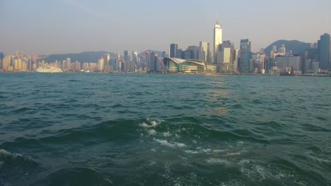 Establishing-shot-from-the-ferry-boat-reveals-Hong-Kong-harbor-and-skyline-with-clouds-2
