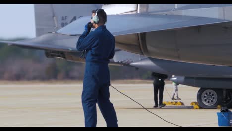 American-Fighter-Jets-Are-Inspected-On-The-Runway-By-Air-Force-Personnel-Before-A-Mission