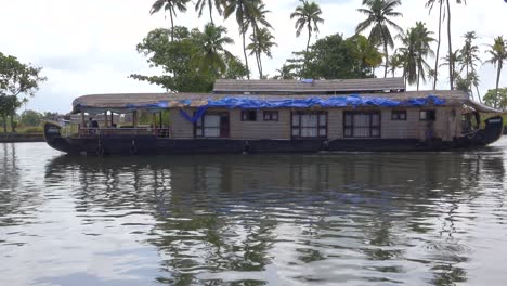 A-tourist-houseboat-travels-upriver-in-Kerala-India-1