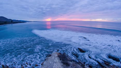 Timelapse-of-the-sun-rising-over-the-breaking-waves-at-Refugio-State-Beach-at-Gaviota-near-Santa-Barbara-California
