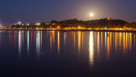 Timelapse-of-a-full-moon-setting-and-boats-leaving-the-Santa-Barbara-Harbor-at-sunrise-in-Santa-Barbara-California