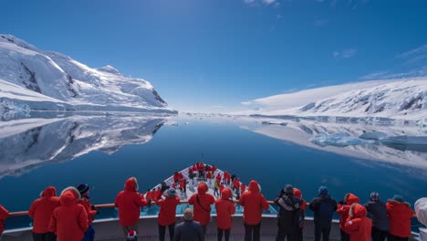 POV-Timelapse-of-ship-bow-and-ice-in-the-Gullet-slow-Antarctica-with-tourists-foreground