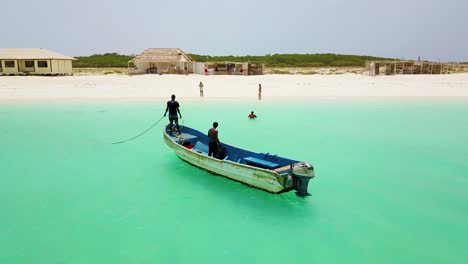 A-beautiful-circular-aerial-around-an-African-fishing-boat-on-beautiful-green-waters-in-Djibouti-or-Somalia