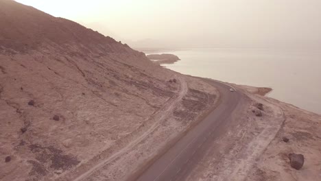 Good-aerial-above-a-pickup-truck-driving-on-a-coastal-road-in-Somalia-or-Djibouti-2
