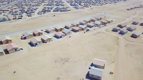 Aerial-over-a-strange-abandoned-town-of-empty-lonely-suburban-tract-houses-in-the-desert-of-Namibia-Africa-6