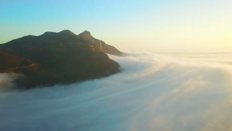 Drone-aerial-above-the-clouds-looking-at-Table-Mountain-and-Twelve-Apostles-behind-Cape-Town-South-Africa-1
