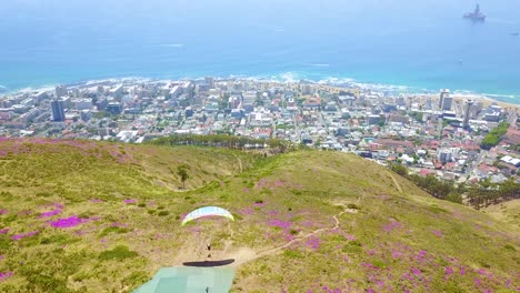 Drone-aerial-over-paragliding-and-paragliders-with-the-downtown-city-of-Cape-Town-South-Africa-in-background-2