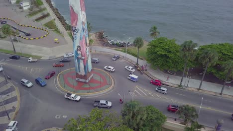 Aerial-over-a-painted-Christian-statue-at-a-traffic-circle-roundabout-in-Santo-Domingo-the-capital-of-the-Dominican-Republic