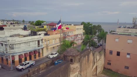 Aerial-around-the-flag-of-the-Dominican-Republic-in-Santo-Domingo