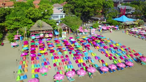 Aerial-over-colorful-beach-umbrellas-in-Sanur-or-Kuta-beach-on-the-coast-of-Bali-Indonesia-2