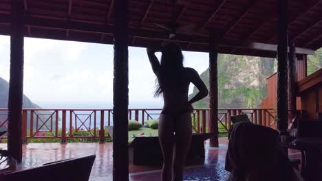 A-sexy-woman-walks-out-onto-a-balcony-of-a-hotel-or-resort-on-the-Caribbean-Island-of-St-Lucia