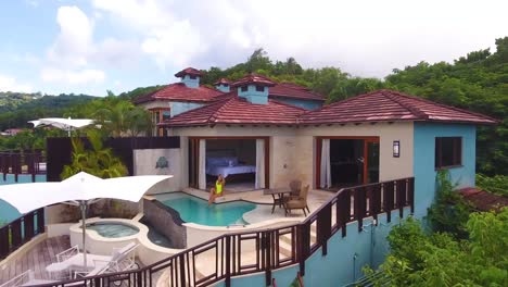 Aerial-of-a-sexy-woman-walking-out-to-a-pool-of-a-condo-or-luxury-home-on-the-Caribbean-Island-of-St-Lucia