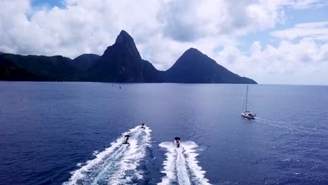 Nice-vista-aérea-establishing-shot-of-luxury-speedboats-boats-fast-passing-under-and-revealing-the-Caribbean-Island-of-St-Lucia