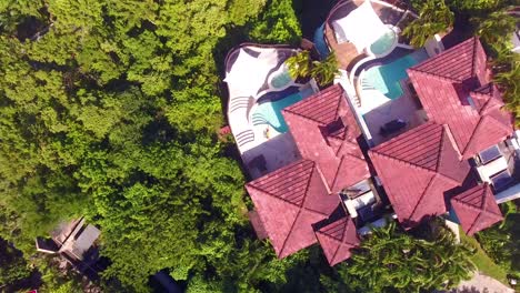 Aerial-of-a-sexy-woman-sitting-beside-a-pool-of-a-condo-or-luxury-home-on-the-Caribbean-Island-of-St-Lucia