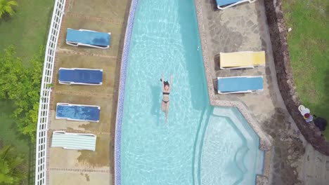 Aerial-of-a-sexy-woman-relaxing-at-a-pool-of-a-condo-or-luxury-home-on-the-Caribbean-Island-of-St-Lucia
