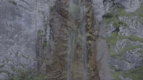 Rising-aerial-of-a-very-tall-waterfall-in-Perucica-primeval-forest-in-Bosnia