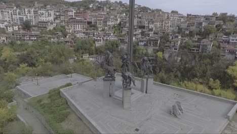Aerial-of-an-old-neighborhood-of-houses-and-homes-near-Sarajevo-Mosnia-with-sculpture-in-foreground