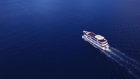 Aerial-over-a-large-yacht-traveling-along-the-coastline-of-Croatia
