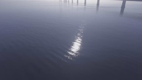 Mysterious-aerial-of-a-bridge-in-the-fog-in-Denmark