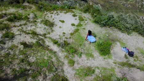 Aerial-shot-woman-running-at-Quilotoa-Ecuador-caldera-in-the-Andes-Mountains