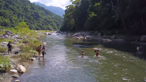 Aerial-over-a-group-of-people-crossing-a-remote-jungle-river-in-Honduras