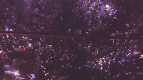 Hypnotic-high-ange-shot-of-huge-crowds-at-a-night-dance-party-club-or-nightclub