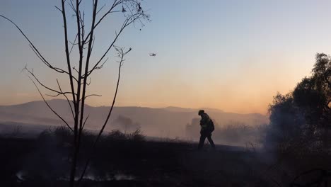 A-Lone-Firefighter-Mops-Up-During-The-Easy-Fire-Wildfire-Disaster-In-The-Hills-Near-Simi-Valley-Southern-California