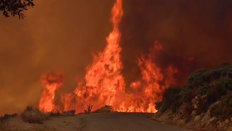 A-Vast-And-Fast-Moving-Wildifre-Burns-Near-A-Road-On-The-Hillsides-Of-Southern-California-During-The-Cave-Fire-In-Santa-Barbara