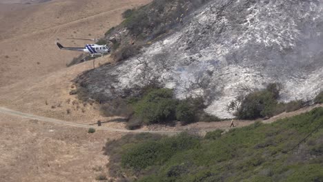 Helicopter-Water-Drop-And-Firefighters-Mop-Up-After-A-Brush-Fire-Burns-A-Hillside-Near-Hollister-Ranch-In-Santa-Barbara-California-2