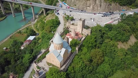 Aerial-Around-A-Beautiful-Castle-And-Church-On-Lake-Zhinvali-In-The-Republic-Of-Georgia
