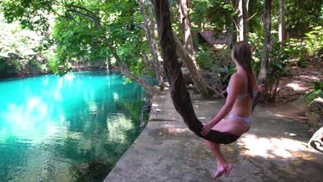 A-Pretty-Girl-Swings-On-A-Rope-Swing-In-Slow-Motion-Beside-A-Hotel-In-Vanuatu-Melanesia-Pacific-Islands