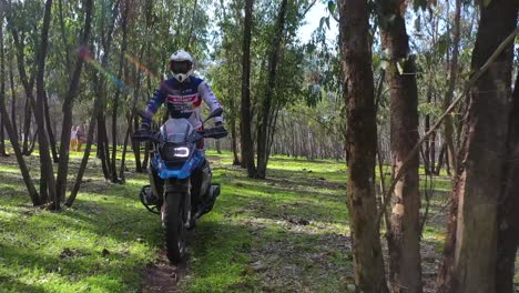 A-Dirt-Bike-Motorcycle-Rider-Drives-Through-A-Forest-Area