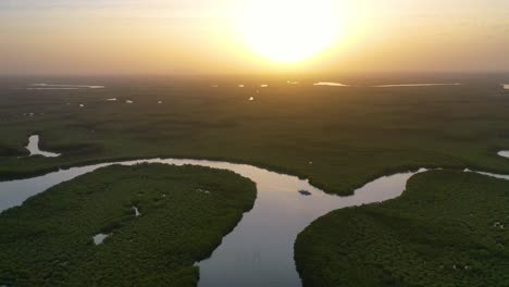 Beautiful-Aerial-Over-Small-Boat-Moving-Along-The-Gambia-River-In-West-Africa-Through-Mangrove-Forests-And-Winding-Bends-4