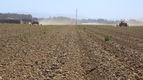 Farm-Tractors-Move-Across-Dry-Dusty-Landscape-In-California-Suggesting-Drought-And-Climate-Change