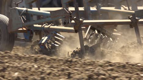 Tractor-Plow-Blades-Move-Through-Dry-Dusty-Earth-In-California-Suggesting-Drought-And-Climate-Change