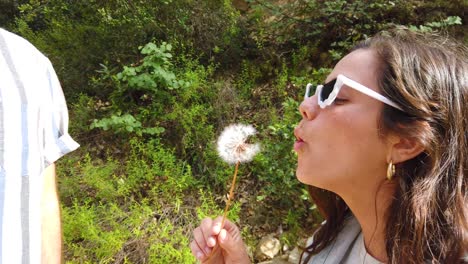 A-Woman-Blows-A-Dandelion-With-Her-Boyfriend-In-Slow-Motion