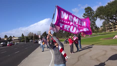Trump-Supporters-Protest-Election-Fraud-In-The-Us-Presidential-Elections-With-Large-Flags-Flying-On-The-Street-In-Ventura-California-Women-For-Trump-Are-Represented