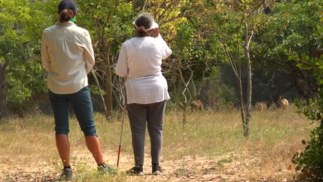 A-Blind-Woman-Walks-With-Stands-Near-Deer-Grazing-With-A-Guide-Helping-Her-Explore-The-Wilderness